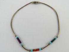 A Native American style turquoise coloured stone and silver beaded bracelet.