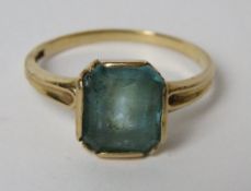 A 10ct gold Art Deco ring having central emerald cut blue stone, stone slightly a/f, size O-P, 2.8g.