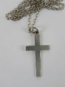 A silver crucifix pendant of plain design, stamped silver, upon white meal chain, 3.
