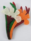 An overlaid plastic brooch in the style of Lea Stein in the form of a floral bouquet,