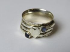 A handmade planished effect three band fidget or worry ring, stamped 925, size M.