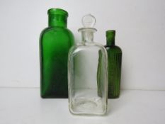 A green glass bottle marked 'Bottled by Jeyes' standing 15cm high.