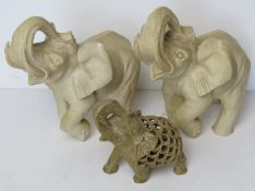 A carved soapstone figurine of an elephant having smaller carved elephant within.
