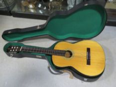 An acoustic guitar made by BM in fitted case bearing vintage label upon.