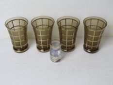 A set of four 1970s smoked glass and gilded lemonade cups,