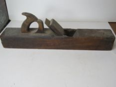 A large vintage wood plane approx 56cm in length.