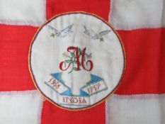 An antique English flag having hand woven tapestry to centre with initial 'M' and 1916 - 1919 India