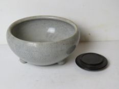 An Oriental grey crackle glaze planter together with an associated hardwood stand.