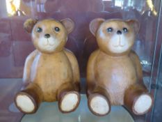 A pair of carved wooden Teddy bear figurines for use as bookends, 18cm high.