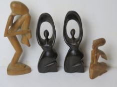 Four hand carved wooden figurines inc pair of fertility figurines standing approx 25.5cm high.