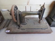 A vintage sewing machine having gilt decoration upon, lid deficient.