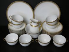A Czechoslovakian tea service comprising six cups and saucers, two cake plates, six side plates,