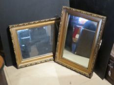 A pair of gilt framed mirrors.