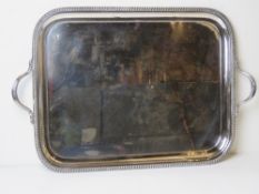 A large heavy silver plated tray having twin end handles.