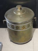 A brass log bin with liner.