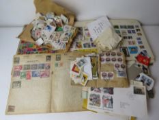 A quantity of assorted loose stamps together with some stuck down stamps and part used albums.
