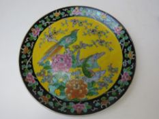 A Japanese ceramic charger in yellow gro