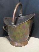 A copper coal scuttle.