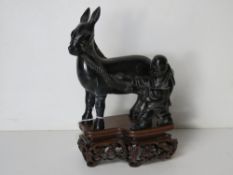 A carved serpentine Oriental figurine of