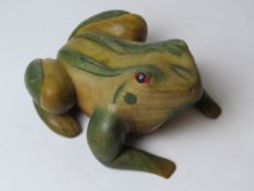 A carved and painted wooden doorstop in
