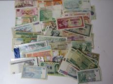 A collection of assorted world paper bank notes including; Peru, Oman, Slovenia, Italy, Guernsey,