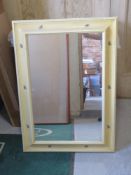A rectangular wall mirror in decorative