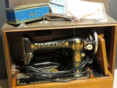 A Singer sewing machine in case with certificate and accessories.