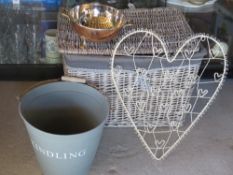 A grey wicker lidded laundry basket toge