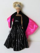 A Special Edition Barbie doll in black and silver dress.