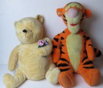 Two large Disney cuddly toys being Winnie the Pooh and Tigger.