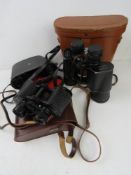Three pairs of Binoculars, all in cases,