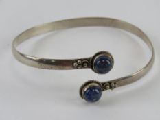 A lapis lazuli bangle, white metal stamp