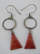 A pair of white metal and faux coral ear