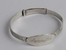 A silver Christening bangle.