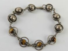 A silver geometric design tiger's eye ca