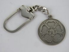 An HM silver key chain having Tudor Rose