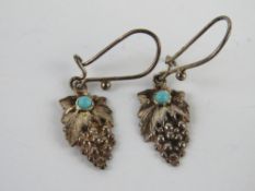 A pair of silver and turquoise earrings