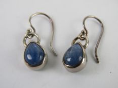 A pair of silver and blue stone earrings