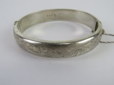 A hallmarked silver hinged bangle having