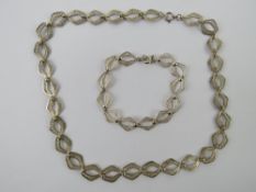 A silver filigree necklace and bracelet