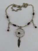 A silver necklace having Native American