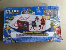 A Disney Club penguin air hockey playset.