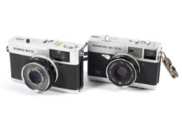 Two Olympus 35mm cameras.
