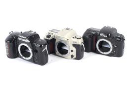 Three Nikon 35mm SLR came bodies.