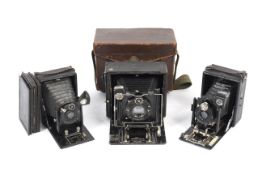 Three large format plate cameras and plate holders.