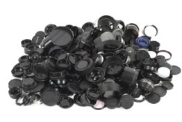 A large collection of camera lens caps and hoods and other accessories.