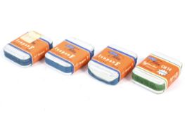 Seven rolls of expired Minox film within four sealed tins.