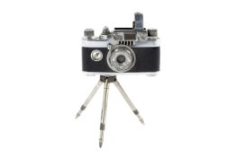 A Lumix lighter in the form of a Leica rangefinder camera on a tripod