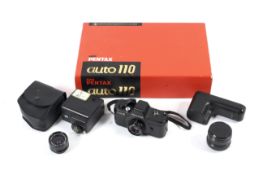 A Pentax Auto 110 sub-miniature SLR camera outfit. To include an Auto 110 body, an 18mm 1:2.
