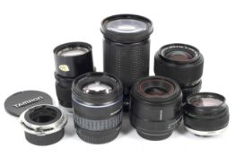 Six Olympus and Olympus OM fit lenses and a Canon to Olympus lens adaptor.